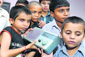 Blind students of National Andh Vidyala listening to PM Narendra Modis speach in Jalandhar on Friday.