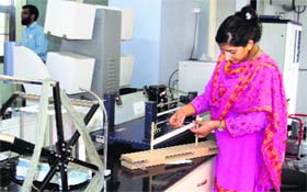 Hina Qazi, project coordinator and test in charge, Pashmina Testing Laboratory and Quality Certification Centre, tests a pashmina thread at the laboratory in Srinagar.