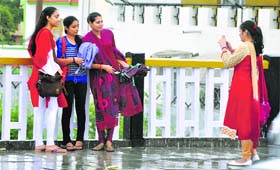 Smile please: People enjoy rain on the Sher-e-Kashmir Bridge in Jammu on Friday.