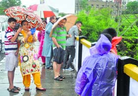 Smile please: People enjoy rain on the Sher-e-Kashmir Bridge in Jammu on Friday.