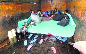 Another family of Bemina lives seeks refuge in a truck as floods have left most of the areas inundated in Srinagar.