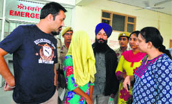 Child protection officer Shilpa (right) and members of the Nav Chetna Bal Bhalai Committee speak to the girl at the Civil Hospital in Ludhiana on Friday. Photo: Inderjeet Verma