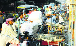 Shopkeepers unload goods in the middle of a road, causing inconvenience to commuters in Ludhiana. Photo: Inderjeet Verma