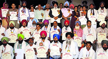 Awarded teachers pose for a picture with Education Minister Daljit Singh Cheema, CPS Inderbir Singh Bolaria and officials in Jalandhar on Friday