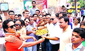 BJP workers distribute ladoos at the Shiv Moorti chowk in Haridwar on Friday to celebrate Narendra Modi-led NDA governments 100 days in office.