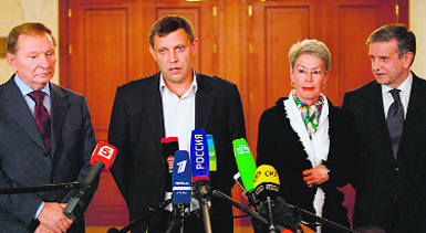 Ukraine Prime Minister Alexander Zakharchenko (2nd L) makes an official statement on the signing of the ceasefire agreement in Minsk on Friday