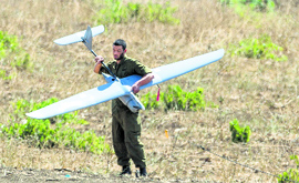 An Israel soldier launches Elbit Systems Skylark-I unmanned aerial drone near the Quneitra crossing, the only border crossing between the Israeli annexed Golan Heights and Syria on Friday.