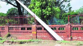 A pillar meant for shifting power lines fell on the boundary wall of a complex due to incessant rains in Amritsar on Saturday.