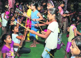 Children perform dandia raas during Ganesh Utsav in Pratap Nagar, Bathinda, on Saturday