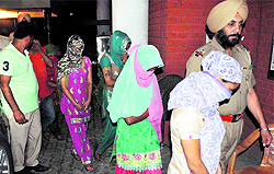 Police personnel take the accused girls into custody in Zirakpur