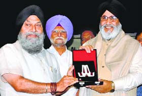 Punjabi University VC Jaspal Singh honours Education Minister Daljit Cheema in Patiala on Saturday. 