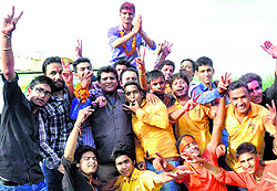 ABVP candidate Naval Negi (top) celebrates with his suppoters after winning the presidents post