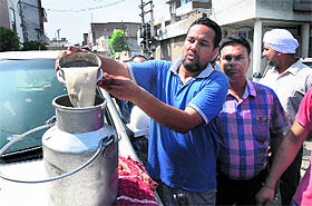 Daljit Singh shows the milk in Bathinda on Sunday.