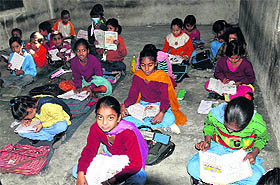Students of Government Elementary School sit on the floor in Bathinda.