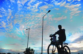 A cyclist rides to his destination on a cloudy Sunday in Chandigarh