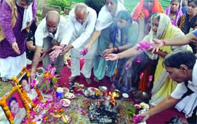 Family members offer prayers outside the High Court complex in memory of the victims of the Delhi High Court bomb blast on the third anniversary of the incident in New Delhi on Sunday.