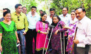 Deputy Commissioner M Sudha Devi hands over crutches to a handicapped woman at Sahoo in Chamba on Saturday