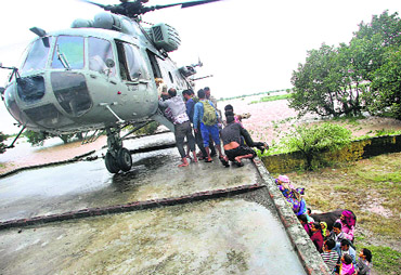 An IAF helicopter rescues people marooned in a flood-hit area of Jammu. 