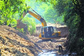 The national highway being cleared of silt in Jammu on Sunday
