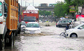 Vehicles move at a snails pace on the flooded Zirakpur-Patiala highway on Monday. 
