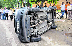 A car overturns after colliding with another car in Sector 8 on Monday. Eyewitnesses said both vehicles were being driven at a high speed.