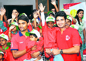 Kings XI Punjab players Sandeep Sharma (left) and Karanveer Singh interact with children of the Smile Foundation at Don Bosco Centre in Sector 24, Chandigarh.