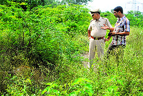 A policeman inspects the spot where the decomposed body was found near Chowk village in Panchkula on Monday. 