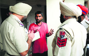 Police personnel question an eyewitness at the spot outside SCD Government College where the two youngsters were attacked in Ludhiana.