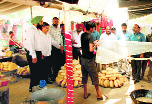 Health officials check the quality of sweets at a stall.