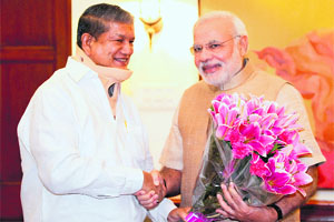 CM Harish Rawat with Prime Minister Narendra Modi in New Delhi on Monday.