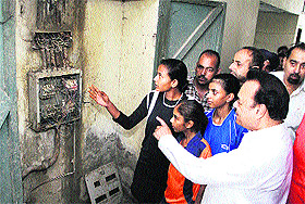 Students show open wires in the hostel to MP Chaudhary Santokh Singh at Govt Girls Senior Secondary School, Nehru Garden Road, Jalandhar, on Tuesday