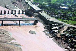 An aerial view taken from an IAF helicopter shows the remains of a bridge on the Tawi in Jammu. 