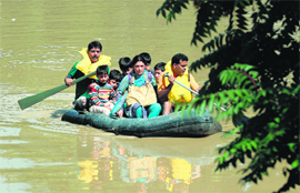 A family is transported by boat through the floodwaters of Srinagar.