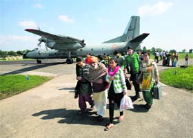 EVACUATED TO SAFETY: People from flood-affected areas of Srinagar disembark from an IAF aircraft at an airport in Jammu on Tuesday