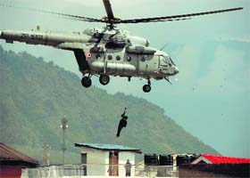 To a safer destination: An IAF helicopter rescues a local from a house submerged in Srinagar on Tuesday
