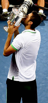 Cilic celebrates with the trophy.