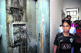 A trainee of the residential wing shows uncovered wires at the school hostel in Jalandhar on Tuesday.