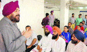 Passport Officer JS Sodhi interacts with applicants at the passport lok adalat in Amritsar on Wednesday.
