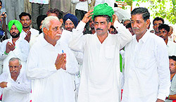 INLD candidate Balwan Singh Daulatpuria (centre) at Kajalheri in Fatehabad on Wednesday