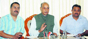 Former Chief Minister PK Dhumal (centre) addresses a press conference in Dharamsala on Wednesday.