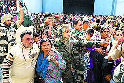 Army jawans escort stranded people to an IAF helicopter in Srinagar on Wednesday