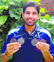Jaspal Singh Grewal flaunts the medals he won at the swimming championship.
