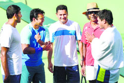 Leander Paes, Rohan Bopanna and Somdev Devvarman share a light moment with captain Anand Amritraj and coach Zeeshan Ali in Bangalore ahead of the Davis Cup. PTI 