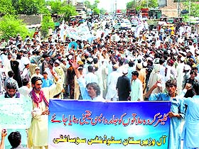Internally displaced civilians protest demanding the government send them back to their homes where military claims the areas are clear of militants, in Bannu on Wednesday.