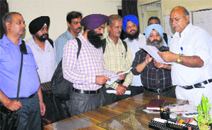 Daily passengers submit a memorandum to the Station Superintendent at the Chandigarh railway station.