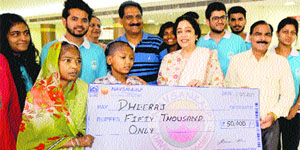 Kirron Kher, MP, Chandigarh, hands over a cheque of Rs 50,000 to Dheeraj. 