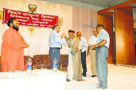102-year-old freedom fighter blesses YS Verma, Vice-Chancellor, CUHP, during Universal Brotherhood Day in Kangra on Thursday