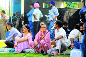 People wait for their relatives outside the Technical Airport in Jammu