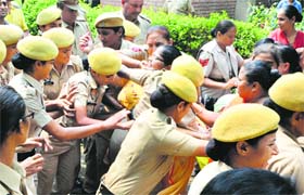 The police prevent anganwadi workers from blocking a road at Shimlapuri in Ludhiana
