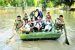 Army personnel rescue people from a flooded area in Srinagar city on Thursday